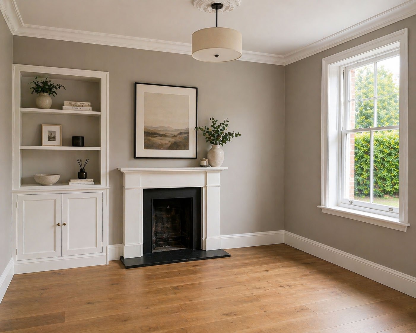 Refurbished period living room in Kensington with warm grey walls and restored fireplace